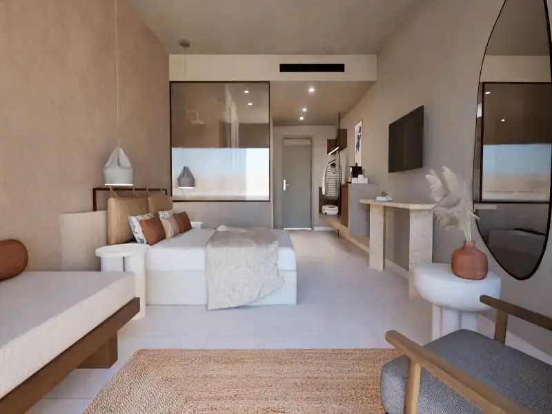 Schlafbereich eines Hotelzimmers mit Fernseher an der Wand und hellem Interieur.