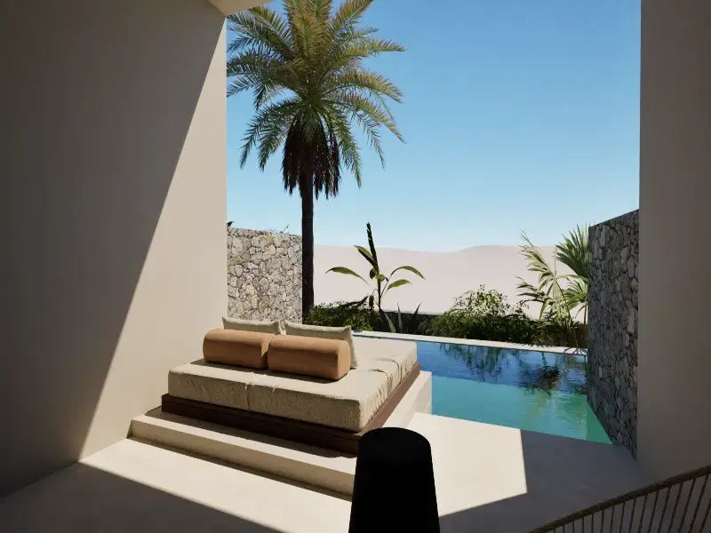 Sonnige Terrasse mit einem Tagesbett direkt am Pool neben einer geschützten Steinmauer.