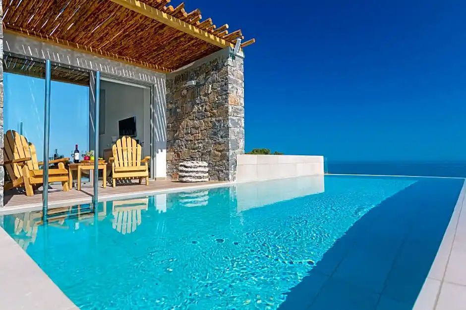 Private Poolterrasse mit Holzüberdachung, Holzstuhl und Blick auf das blaue Meer.