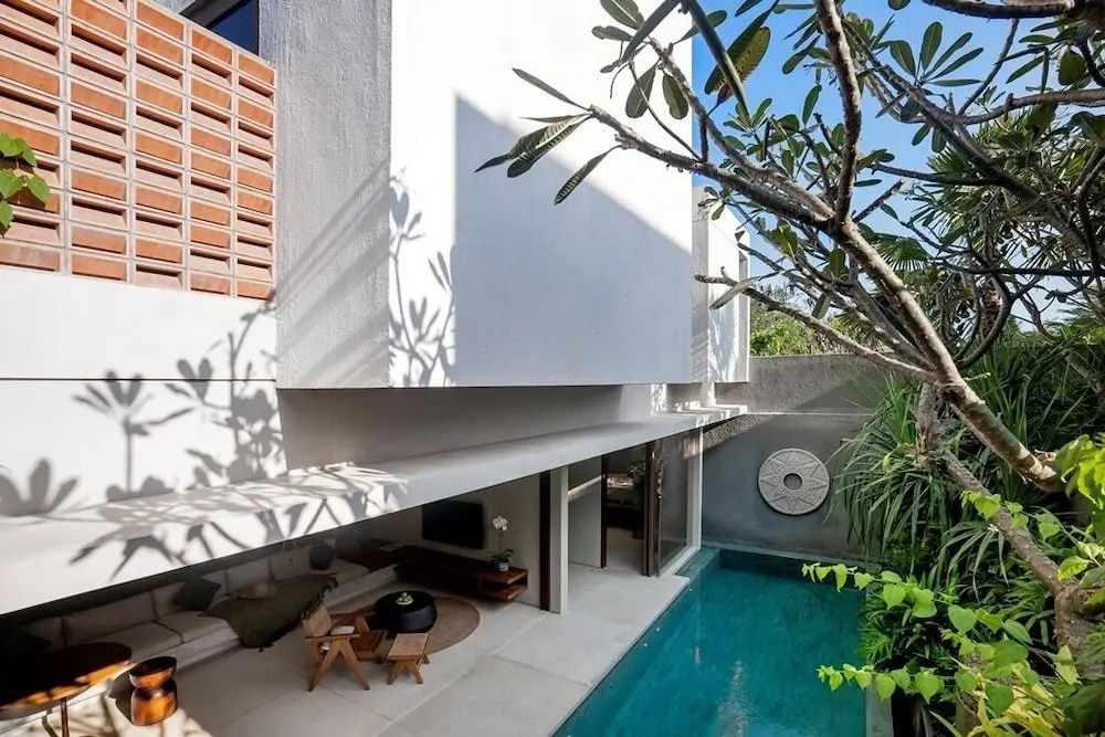 Außenansicht einer modernen Villa mit Terrasse und kleinem Pool.