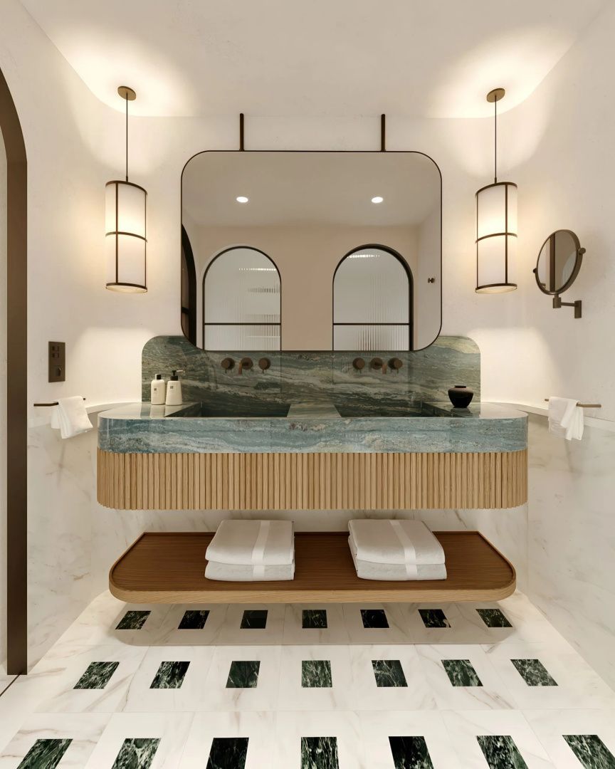Modernes Badezimmer mit zwei Waschbecken aus grünem Stein, großem Spiegel und Hängeleuchten.