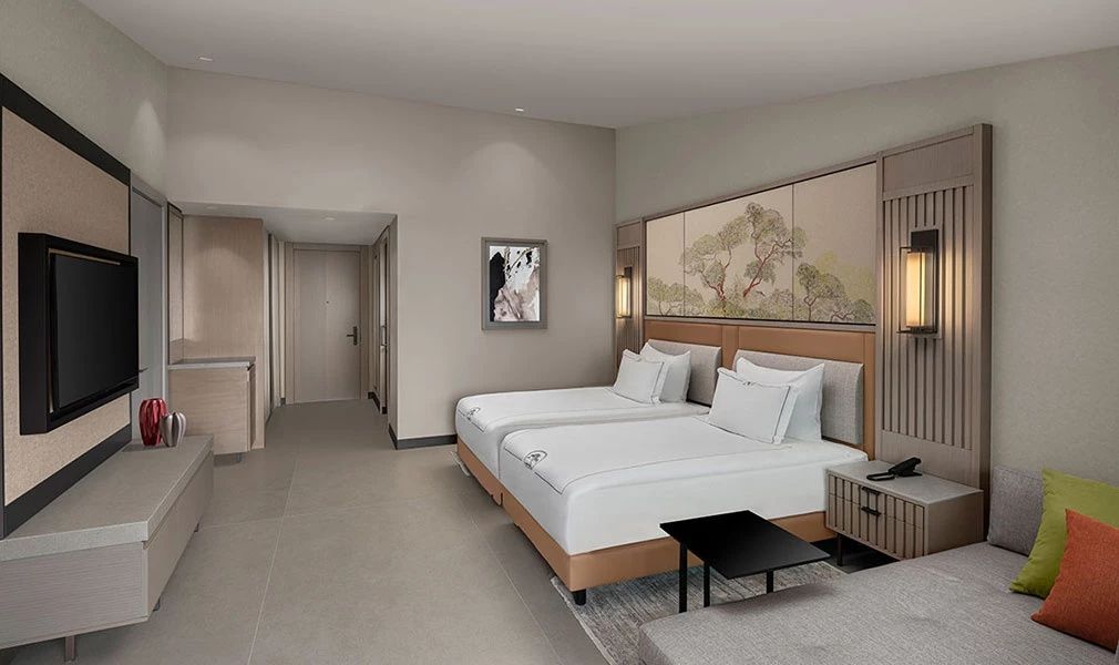 Zwei Einzelbetten mit weißer Bettwäsche in einem modern eingerichteten Hotelzimmer.