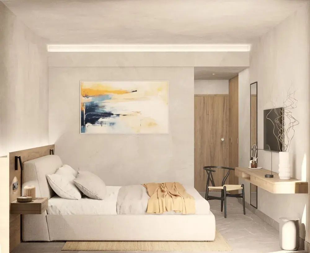 Modernes Doppelbett mit beigefarbener Bettwäsche und abstraktem Bild an der Wand.