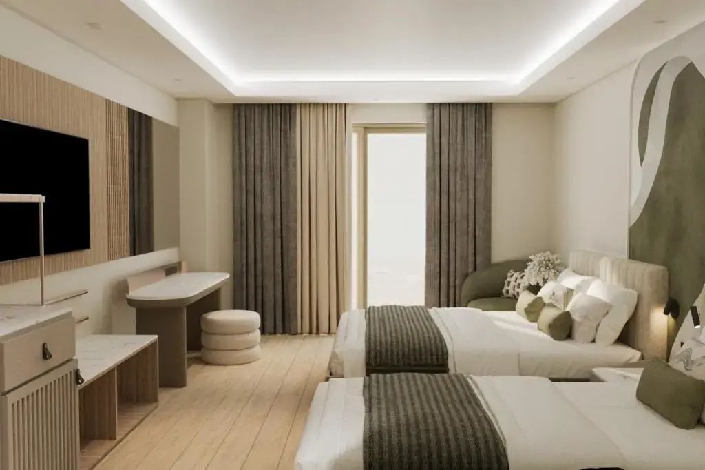 Modernes Zimmer mit zwei Einzelbetten, Holzfußboden, Schminktisch und Sessel.