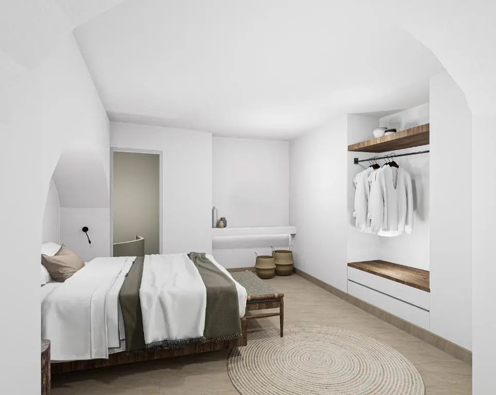 Schlafbereich mit weiß zubereitetem Doppelbett, runder Matte und offenem Kleiderschrank.