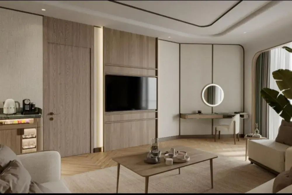 Wandbereich im Hotelzimmer mit Flachbild-TV, Holzpaneel und Frisiertisch.