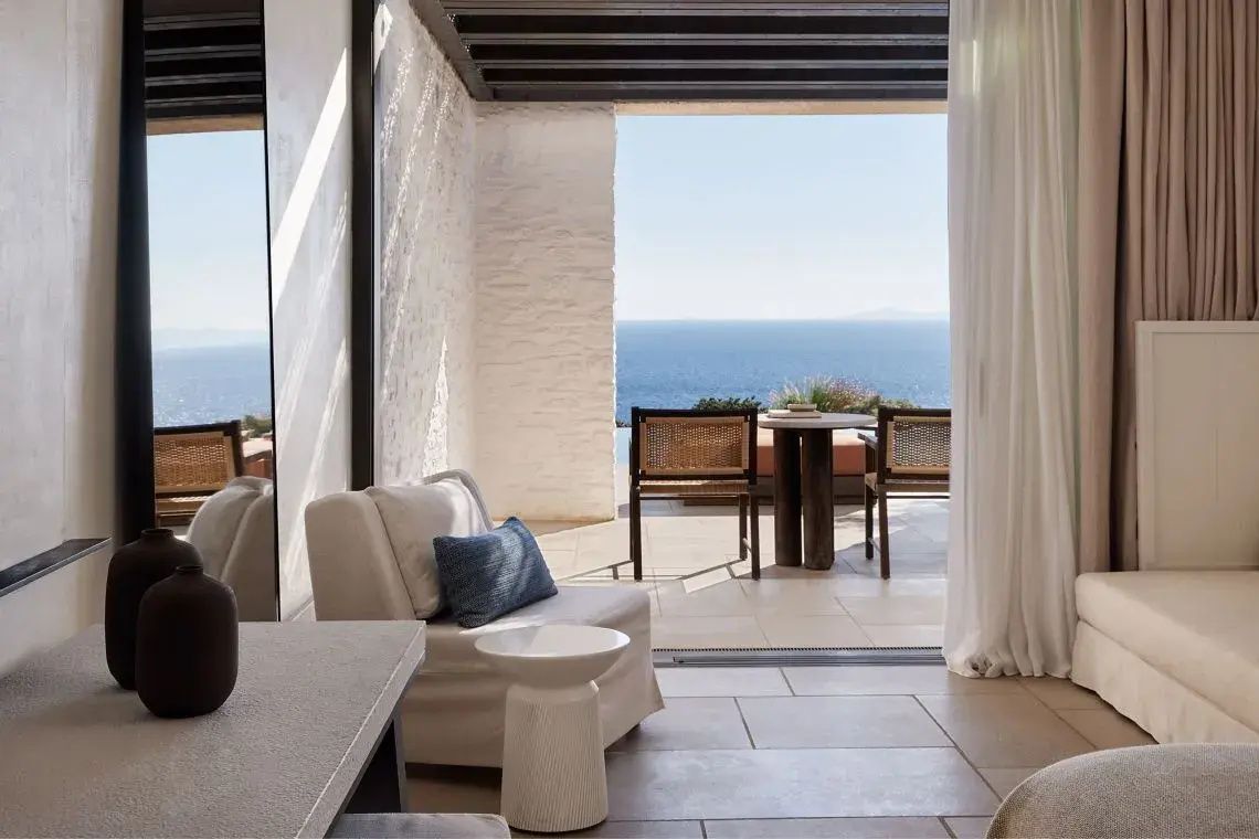 Sitzbereich einer Terrasse mit direktem Blick auf das blaue Meer.