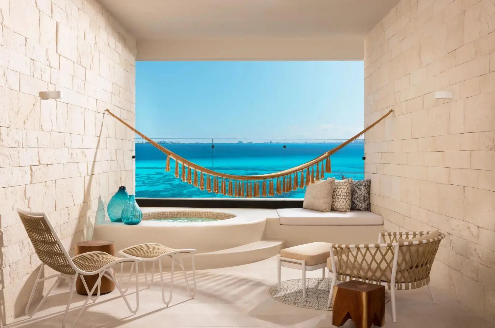 Balkon mit Whirlpool, Hängematte und Sitzgelegenheiten sowie freier Sicht auf den Ozean.