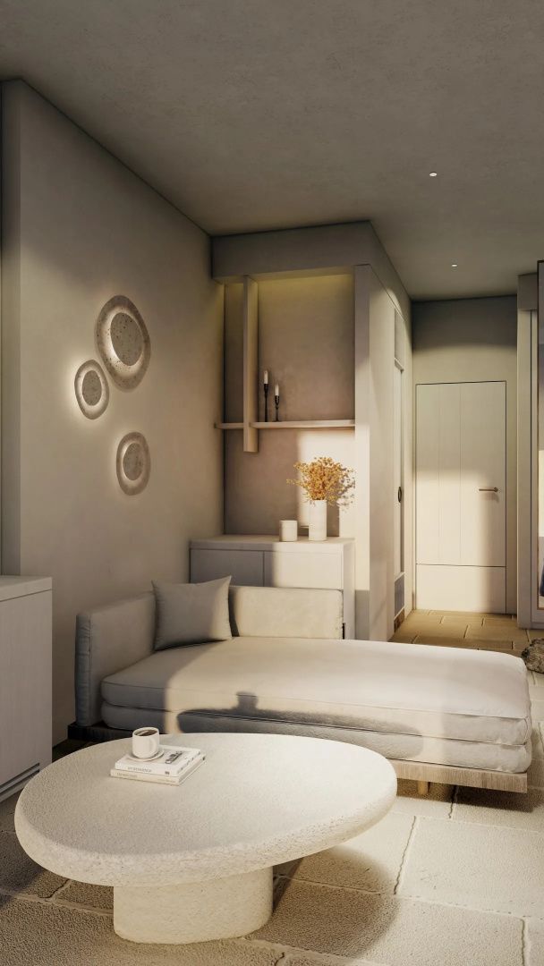 Sitzecke mit Tagesliege, runden Wandleuchten und Dekoration in der Suite.