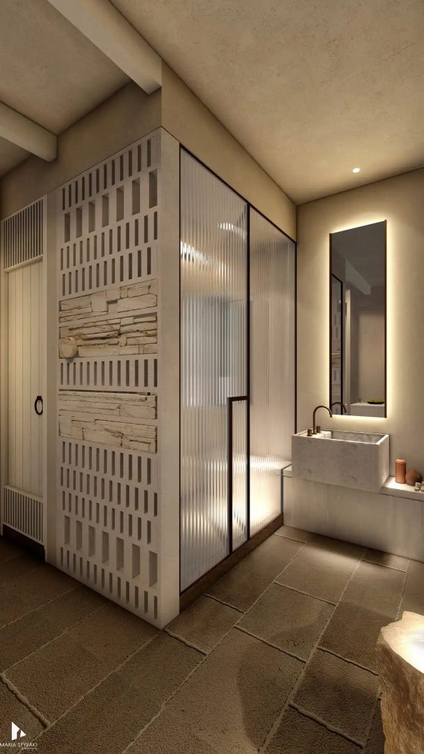 Modernes Badezimmer mit einem Marmorwaschbecken, beleuchtetem Spiegel und einer Dusche mit Riffelglas.
